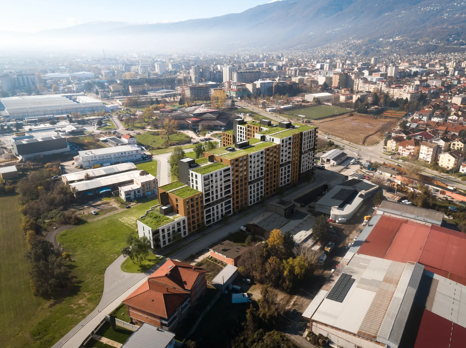 Wide aerial view of Akora Living's position within Tetovo, with the Šar Mountains behind